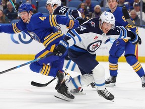 Buffalo Sabres defenceman Bowen Byram and Winnipeg Jets right wing Gustav Nyquist collide Monday. Jeffrey T. Barnes/The Associated Press