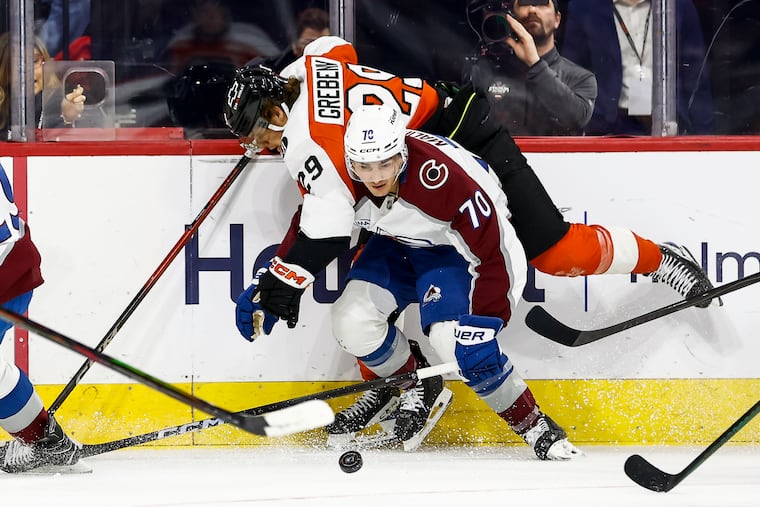 Philadelphia Flyers right wing Nikita Grebenkin collides with Colorado Avalanche defenseman Sam Malinski during the first period.