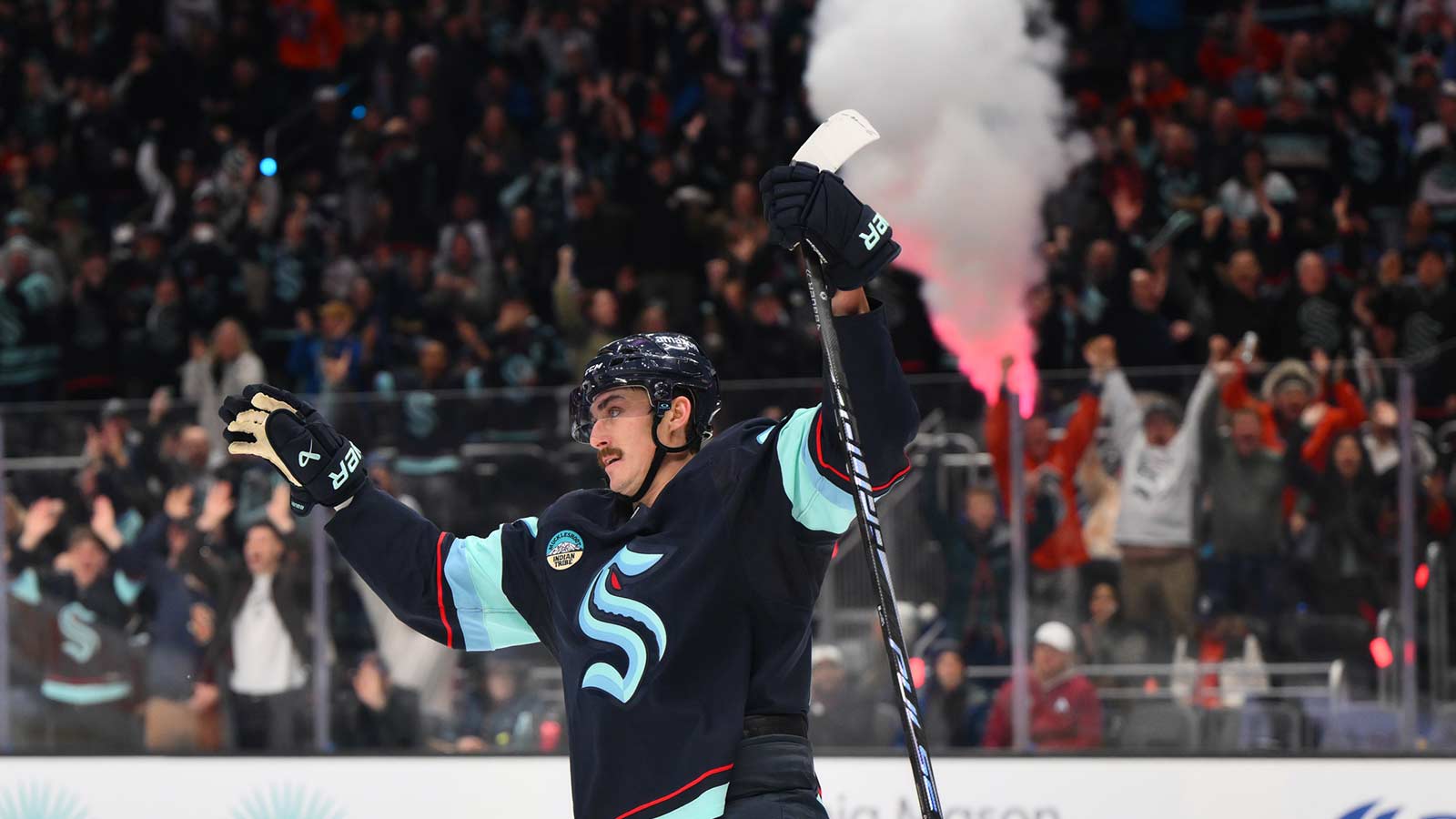 Seattle Kraken left wing Mason Marchment (27) celebrates a goal scored by right wing Jordan Eberle (7) (not pictured) during the second period against the Colorado Avalanche at Climate Pledge Arena.