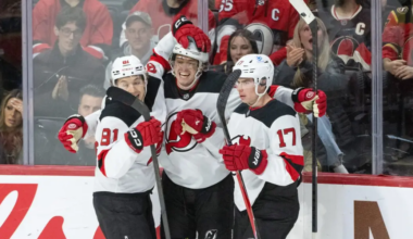 New Jersey Devils' Arseny Gritsyuk (81), Cody Glass (12-middle) and Simon Nemec (17) celebrate Glass' third period goal against the Ottawa Senators.