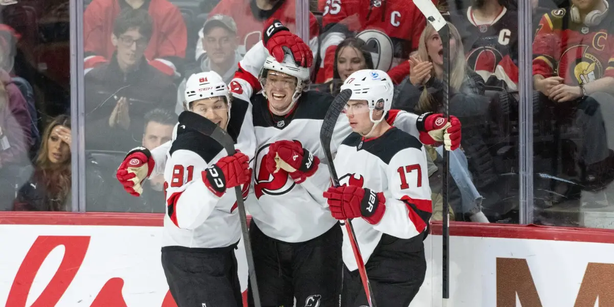 New Jersey Devils' Arseny Gritsyuk (81), Cody Glass (12-middle) and Simon Nemec (17) celebrate Glass' third period goal against the Ottawa Senators.
