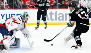 Washington goalie Logan Thompson defends New Jersey Devils Captain, Nico Hischier, during the second period of Saturday's contest at the Prudential Center.