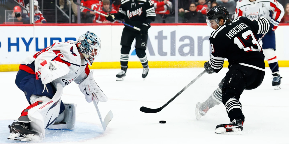 Washington goalie Logan Thompson defends New Jersey Devils Captain, Nico Hischier, during the second period of Saturday's contest at the Prudential Center.