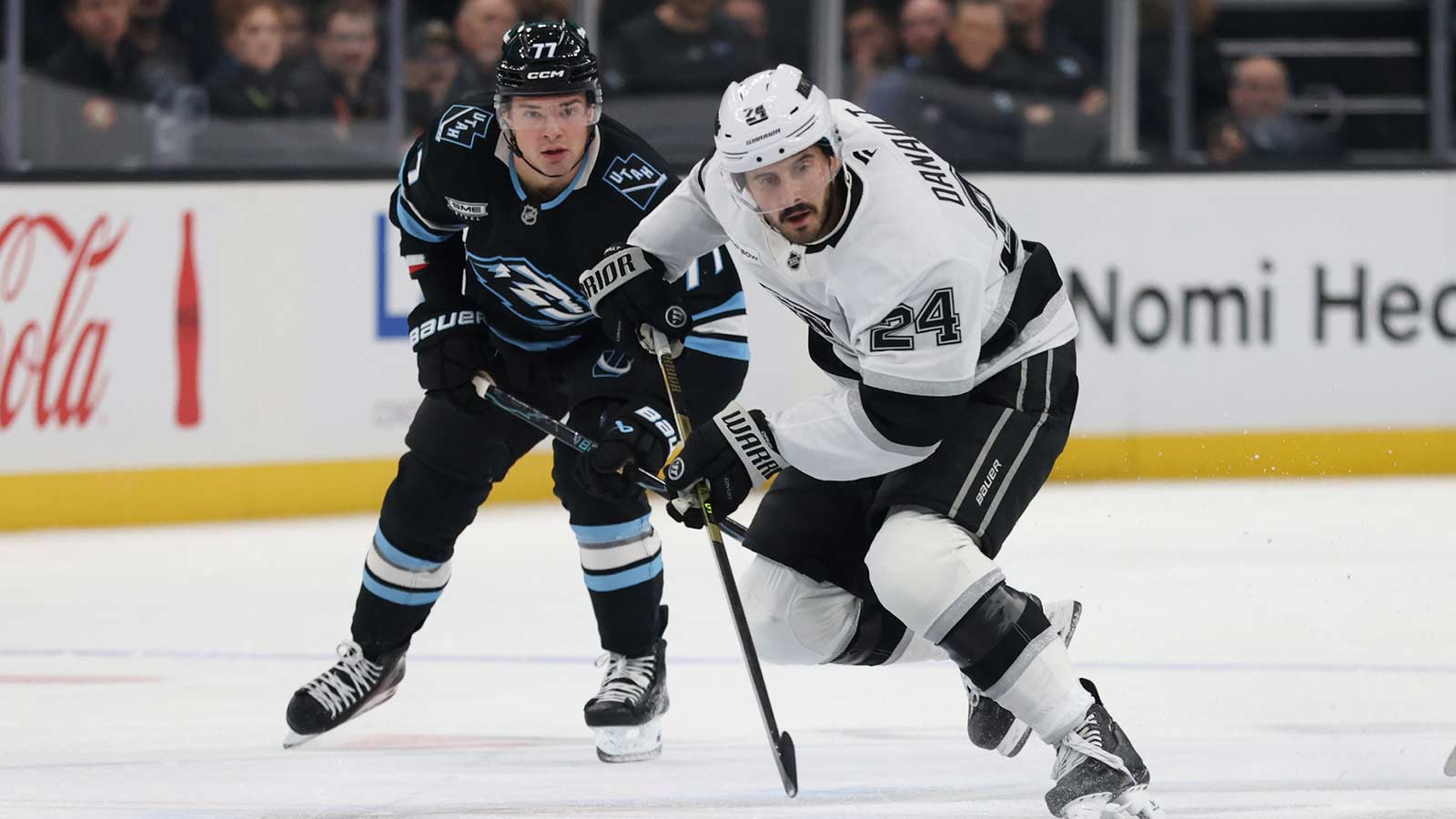 Los Angeles Kings center Phillip Danault (24) controls the puck against Utah Mammoth right wing JJ Peterka (77) during the first period at Delta Center.