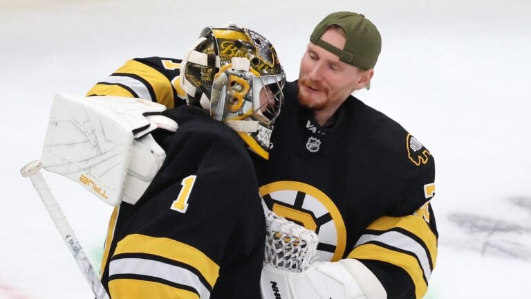 Boston Bruins' Joonas Korpisalo celebrates with Jeremy Swayman (1) after the Bruins defeated the Buffalo Sabres during an NHL hockey game, Saturday, Oct. 11, 2025, in Boston.