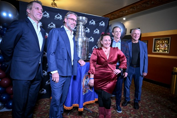 Brianna Mays poses with 1996 members of the Colorado Avalanche Stanley Cup championship team from left to right Sandis Ozolinsh, Peter Forsberg, Joe Sakic and Claude Lemieux at the Paramount Theater in Denver on Wednesday 10, 2025. (Photo by AAron Ontiveroz/The Denver Post)