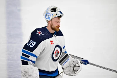 Laurent Brossoit, NHL goaltender, skates during pregame with Winnipeg Jets