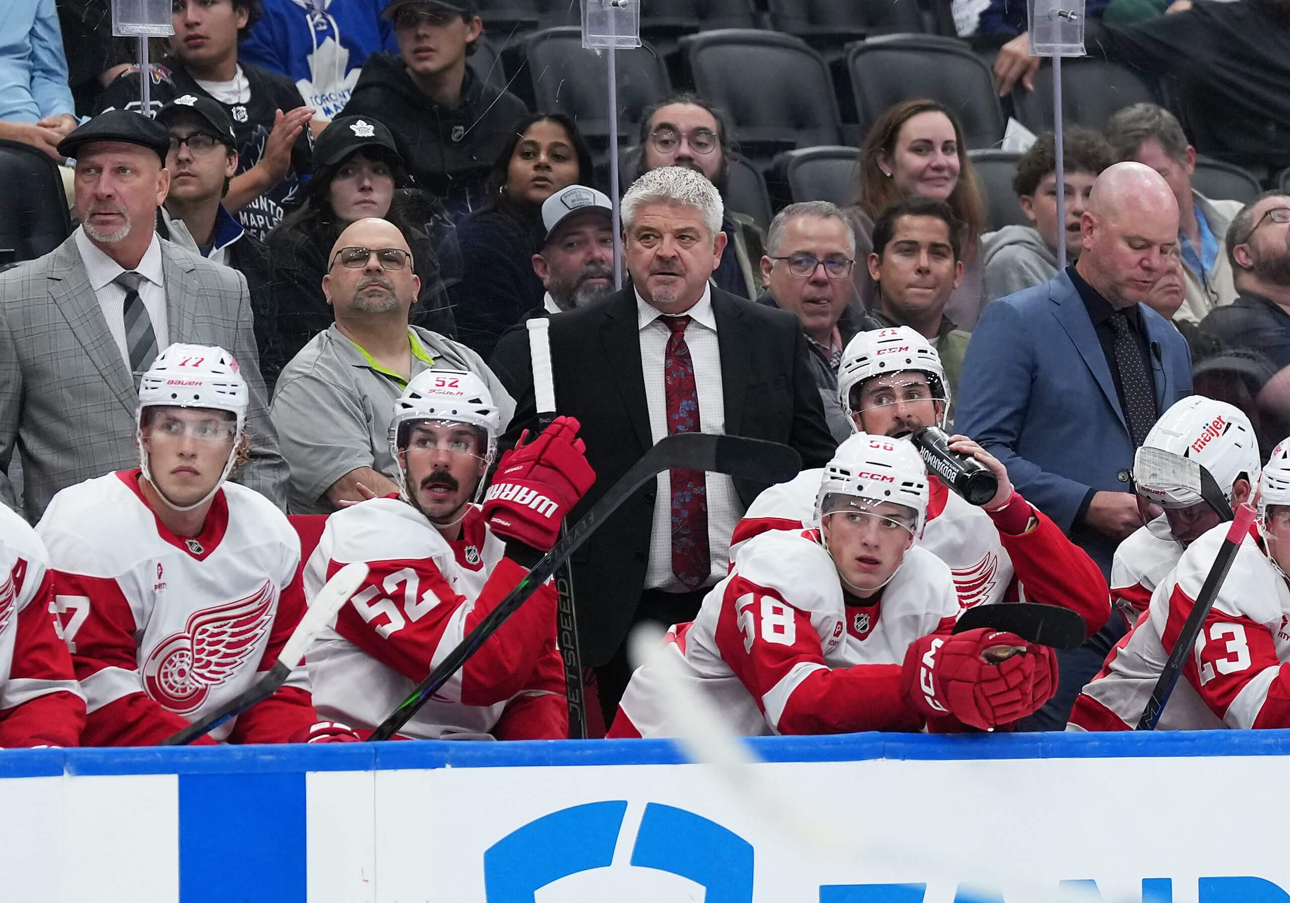 Todd McLellan stands on the Red Wings bench during a preseason game.