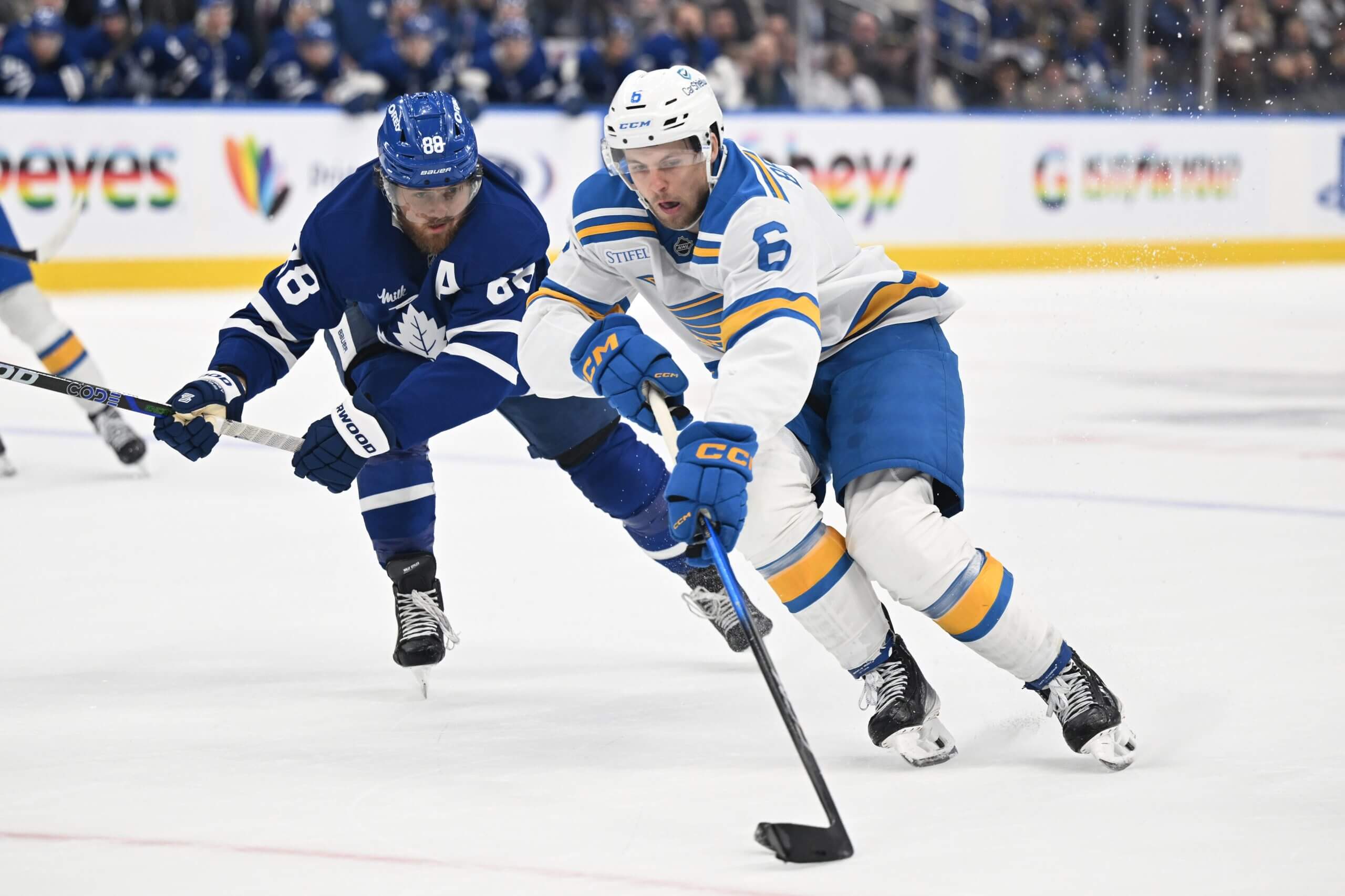 Philip Broberg skates the puck up the ice with Toronto's William Nylander in pursuit.