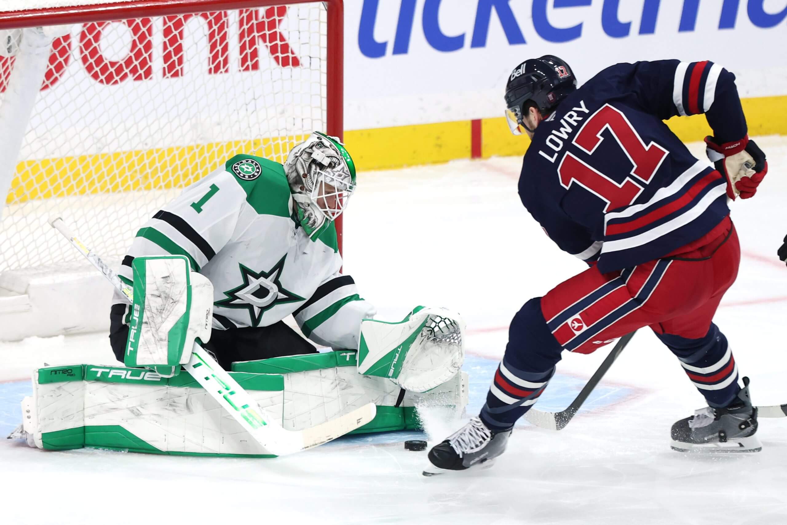 Adam Lowry tries to get the puck past Dallas goalie Casey DeSmith.