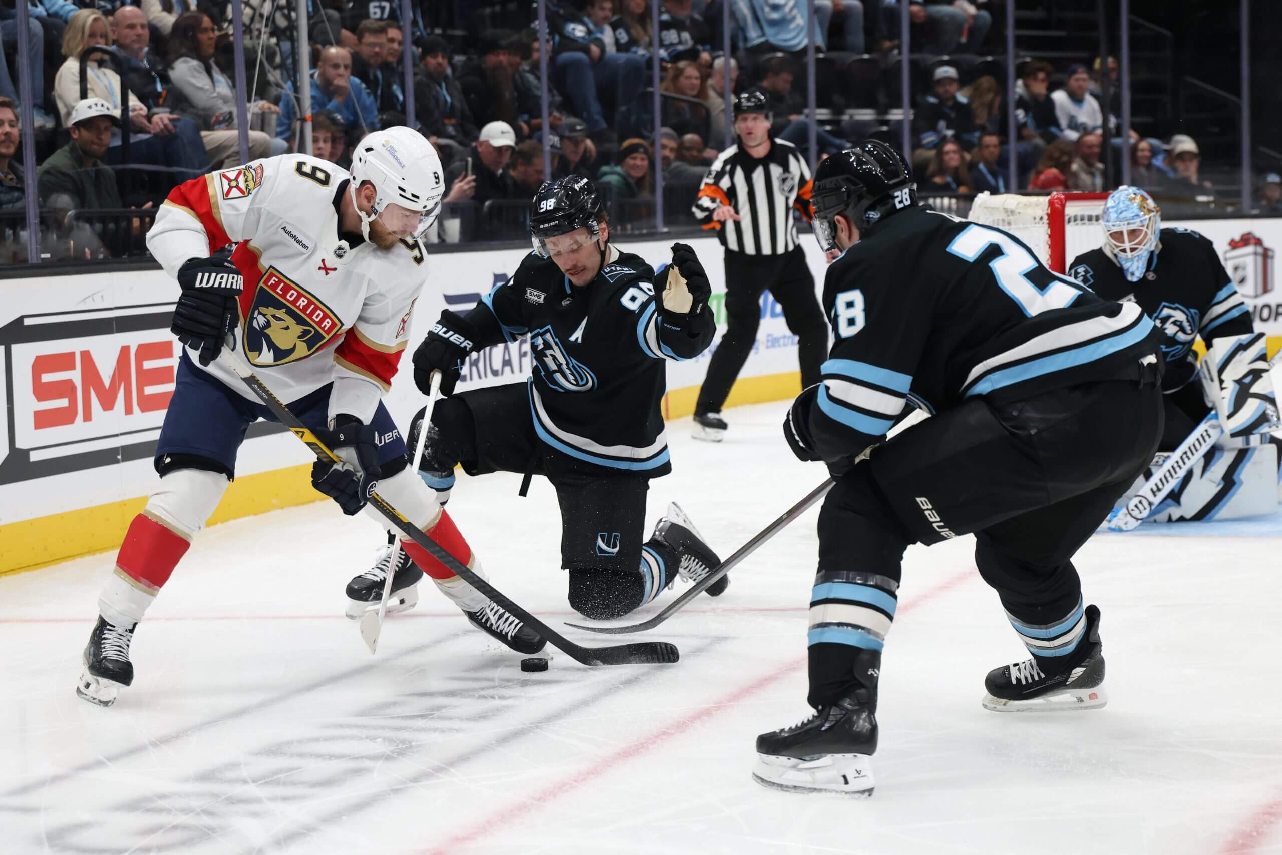 Mammoth defensemen Ian Cole and Mikhail Sergachev try to block Florida Panthers forward Sam Bennett.