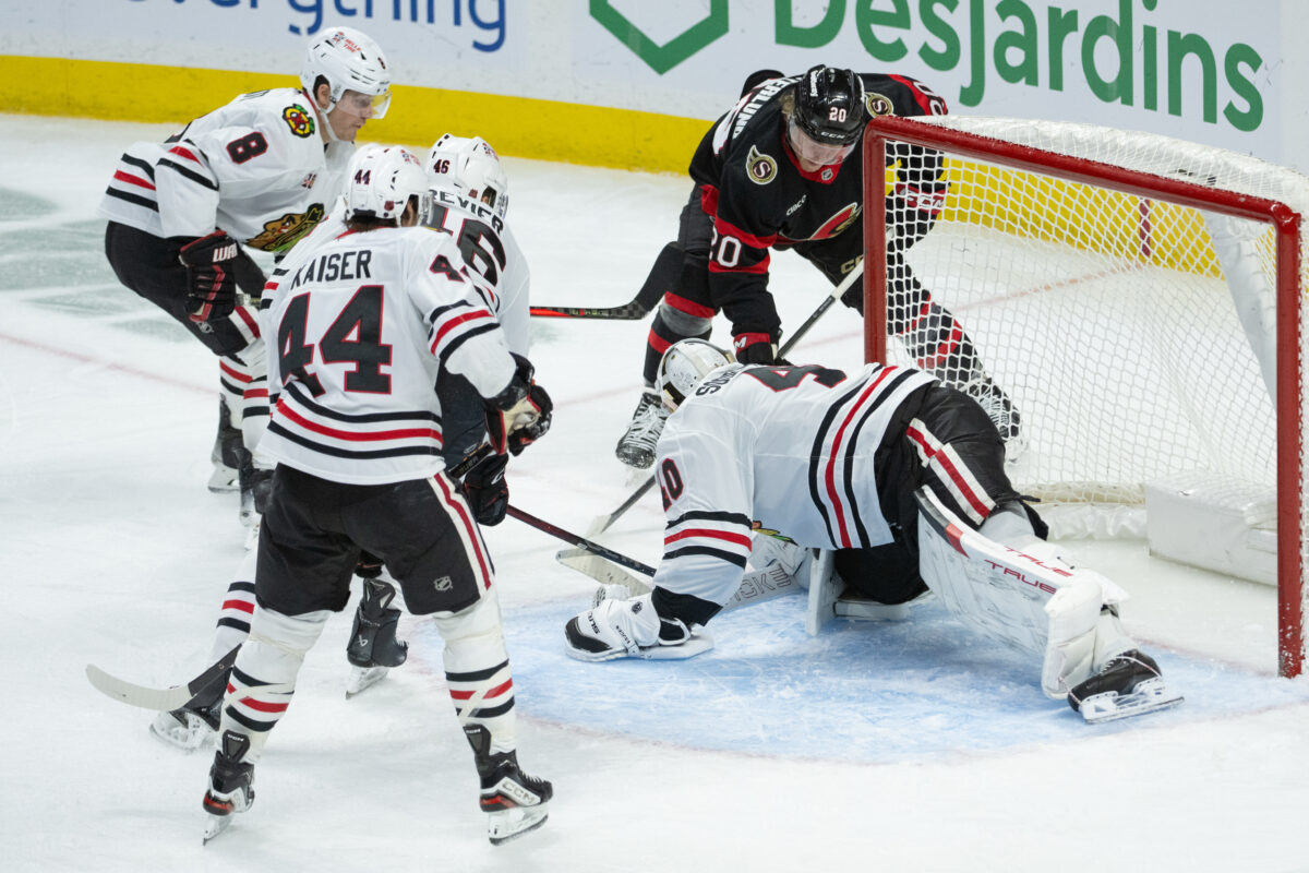 Dec 20, 2025; Ottawa, Ontario, CAN; Chicago Blackhawks goalie Arvid Soderblom (40) makes a save in front of Ottawa Senators left wing Fabian Zetterliund (20) in the third period at the Canadian Tire Centre.
