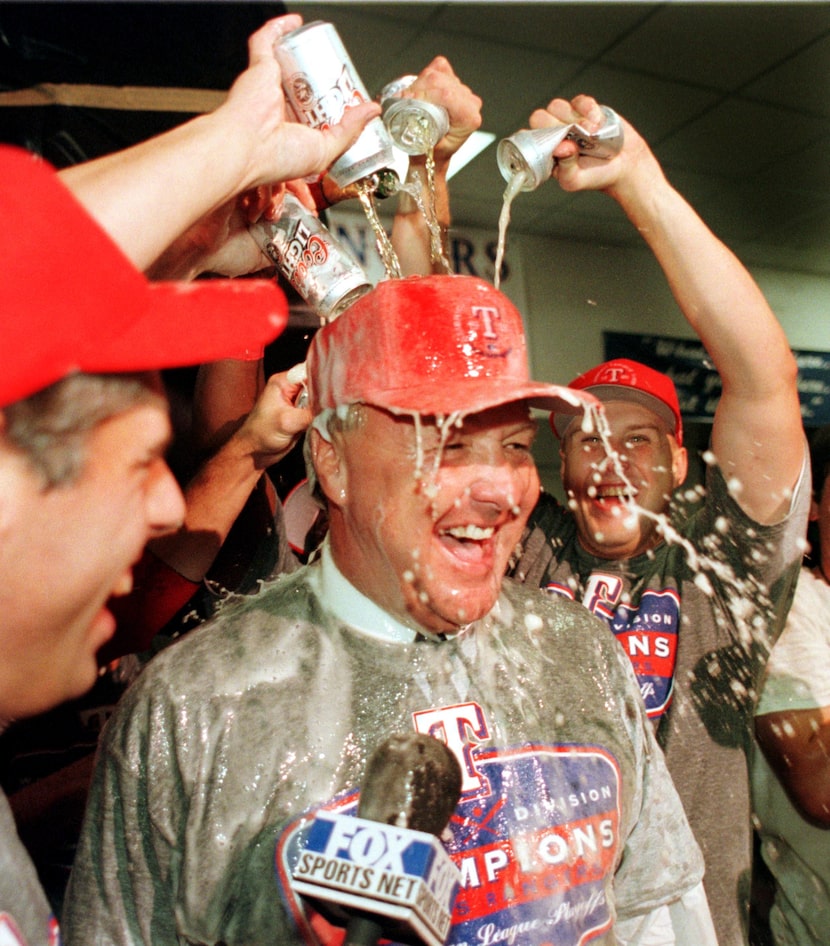 Texas Rangers owner Tom Hicks is drenched by his baseball players during the post game...