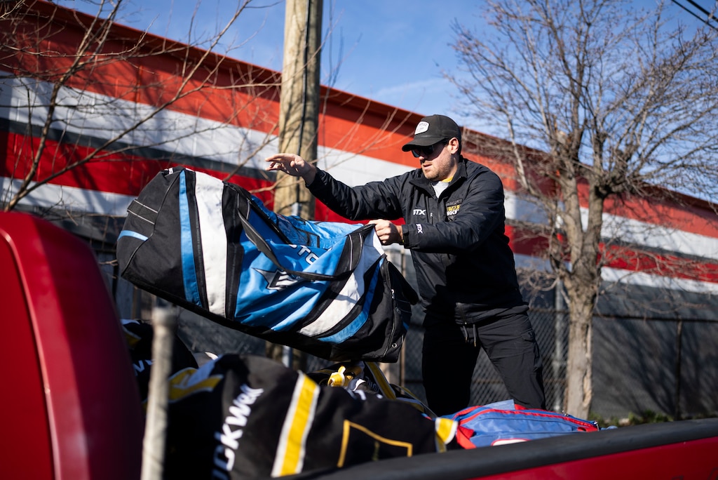 Matt Leone, a coach at The Baltimore Banner hockey team loads a truck with bags full of gear to bring it to Mt. Pleasant Ice Arena where the team is currently practicing at, in Baltimore, Saturday, December 20, 2025.