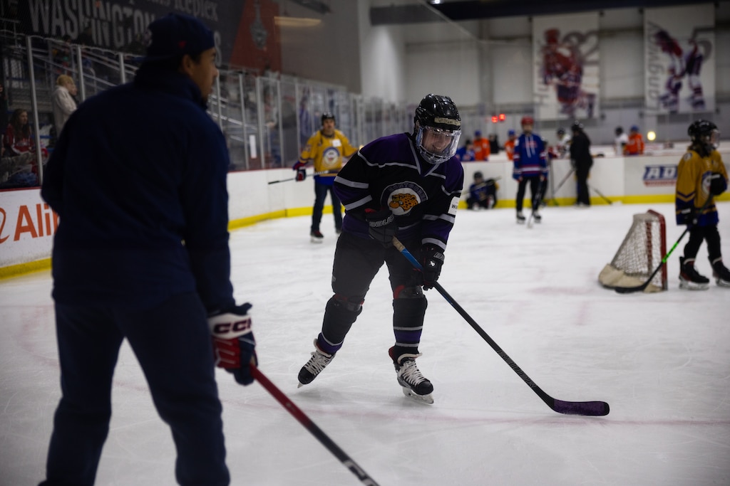 Teams from The American Special Hockey Association, including the Montgomery County Cheetahs (in purple and black), play with Capitals players Alexander Ovechkin, Justin Sourdif, Ethen Frank and veteran Mike Green at the Medstar Iceplex in Arlington, VA on December 10, 2025.