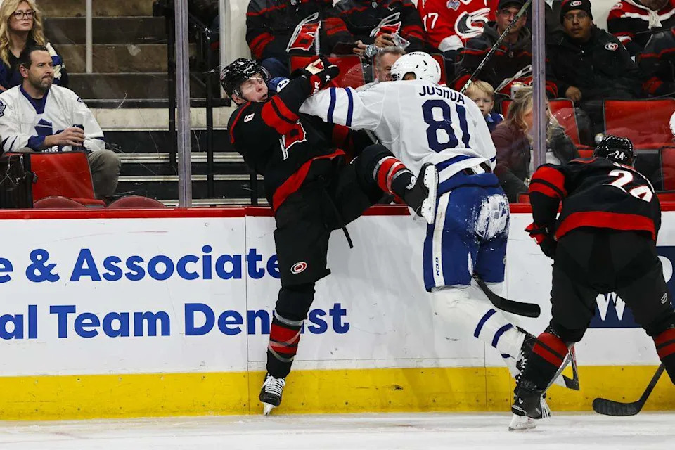 Dakota Joshua (81) of the Toronto Maple Leafs pushes Mike Reilly (6) of the Carolina Hurricanes during the third period at Lenovo Center on Dec. 4, 2025 in Raleigh, North Carolina.