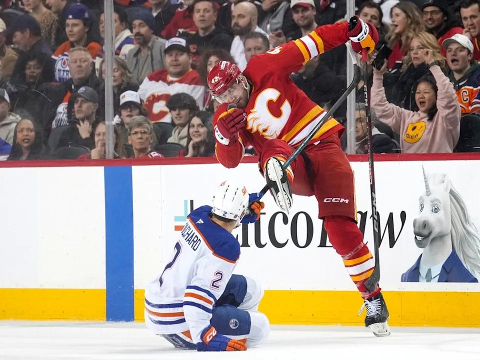  Flames forward Adam Klapka battles Oilers defenceman Evan Bouchard.