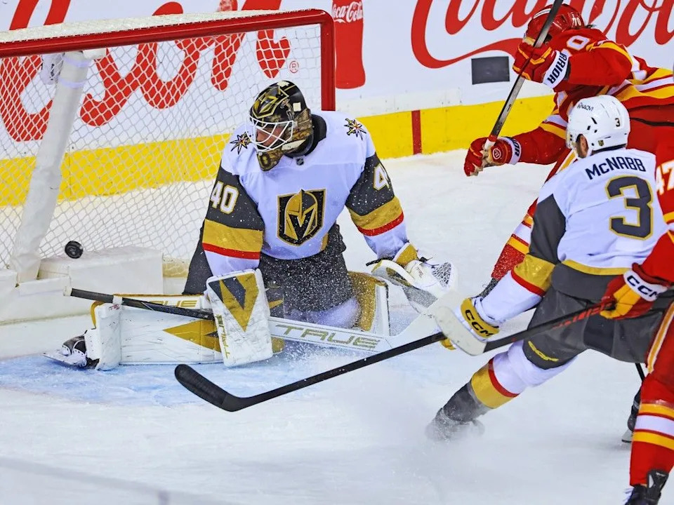 Flames forward Ryan Lomberg scores on Golden Knights goalie Akira Schmid on Saturday.