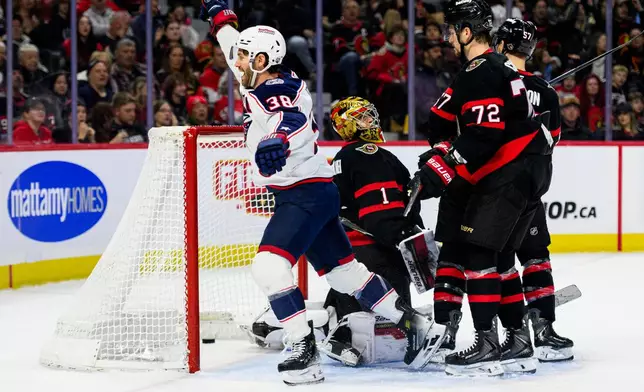 Columbus Blue Jackets' Boone Jenner (38) celebrates his goal on Ottawa Senators goaltender Leevi Merilainen (1) during the first period of an NHL hockey game, in Ottawa, Ontario, Monday, Dec. 29, 2025. (Spencer Colby/The Canadian Press via AP)