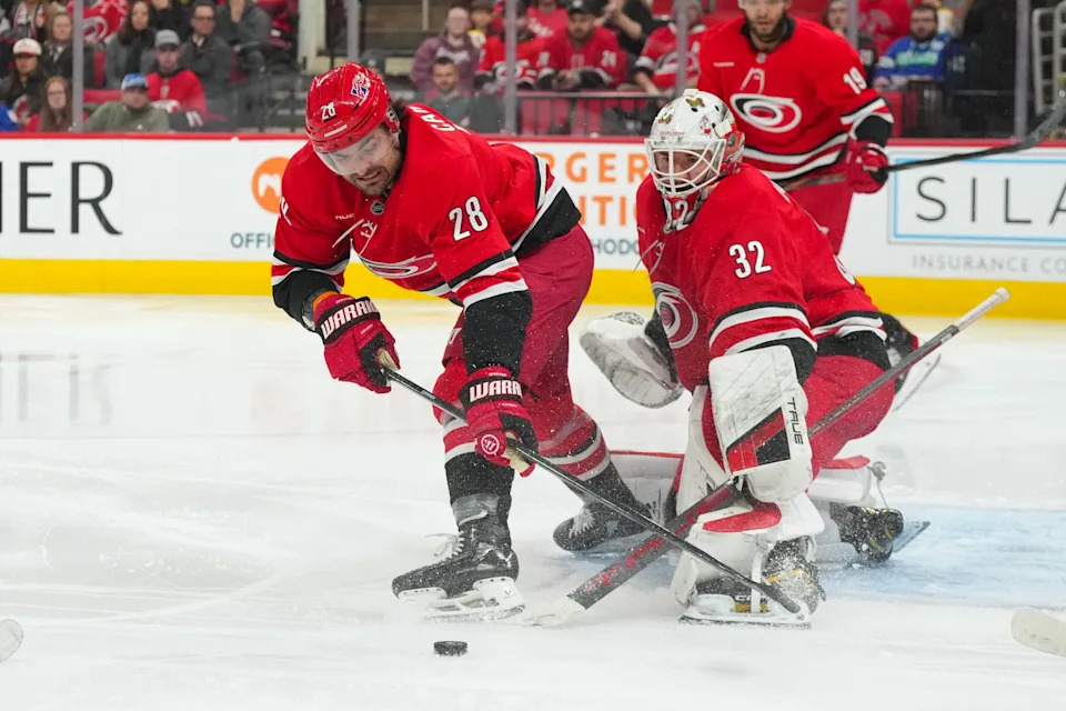 Dec 9, 2025; Raleigh, North Carolina, USA; Carolina Hurricanes goaltender Brandon Bussi (32) and left wing William Carrier (28) watch the shot against the Columbus Blue Jackets during the second period at Lenovo Center. Mandatory Credit: James Guillory-Imagn Images