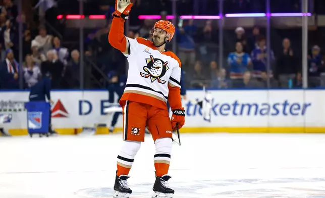 Anaheim Ducks left wing Chris Kreider acknowledges fans during a tribute to him at an NHL hockey game against the New York Rangers, Monday, Dec 15, 2025, in New York. (AP Photo/Noah K. Murray)