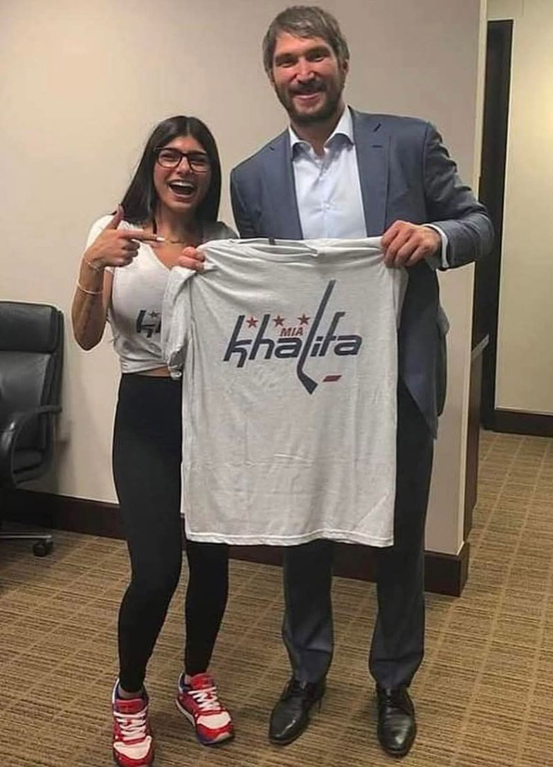 Mia Khalifa holds up a shirt with Alex Ovechkin