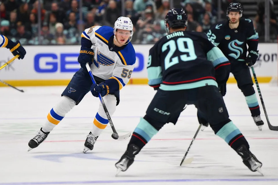 St. Louis Blues center Nikita Alexandrov (59) plays the puck while defended by Seattle Kraken defenseman Vince Dunn (29) during the third period at Climate Pledge Arena. 
