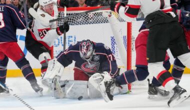 Columbus Blue Jackets goaltender Jet Greaves (73) covers the puck between Ottawa Senators left wing Fabian Zetterlund (20) and left wing Brady Tkachuk (7) in the second period of an NHL hockey game Thursday, Dec. 11, 2025, in Columbus, Ohio. (AP Photo/Sue Ogrocki)