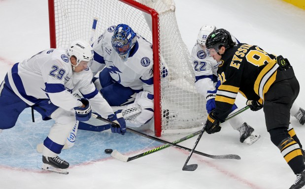 Boston, MA - Oct. 13 - Michael Eyssimont (81) of the Boston Bruins tries to get through Oliver Bjorkstrand (22) and Pontus Holmberg (29) of the Tampa Bay Lightning to score on Jonas Johansson during the first period at the Garden. (Photo By Matt Stone/Boston Herald).