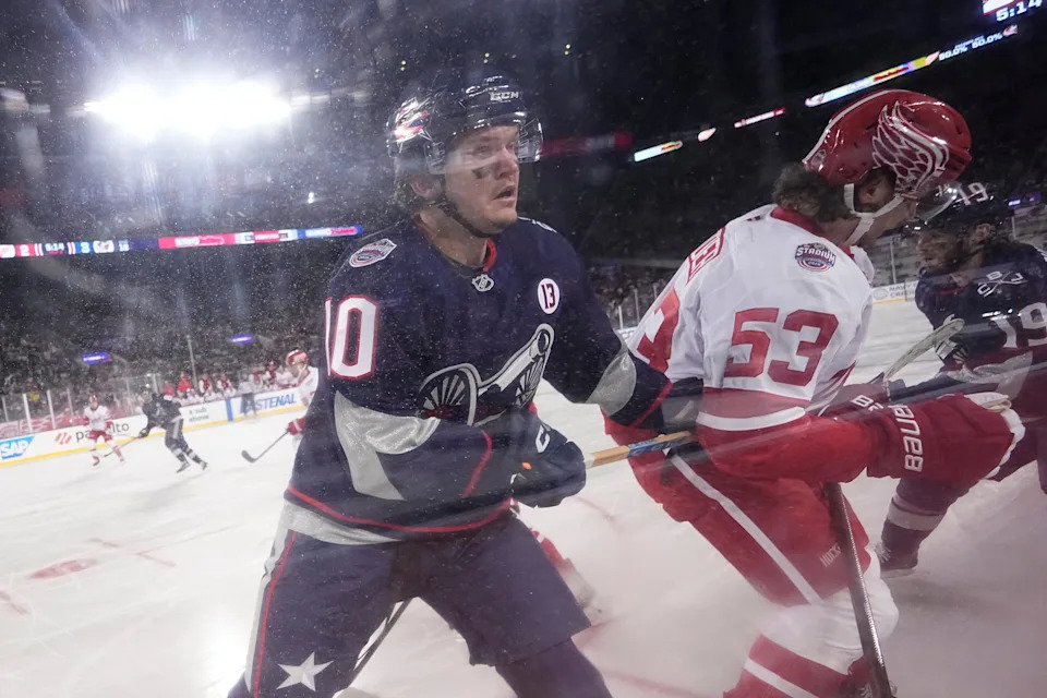 Columbus Blue Jackets left wing Dmitri Voronkov (10) hits Detroit Red Wings defenseman Moritz Seider (53) during the third period of the NHL Stadium Series game at Ohio Stadium on March 1, 2025. The Blue Jackets won 5-3.