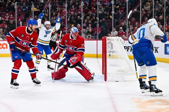  Brayden Schenn (#10) of the St. Louis Blues celebrates his goal as goaltender Jakub Dobes of the Montreal Canadiens looks at his net during the first period at the Bell Centre on Sunday, December 7, 2025.