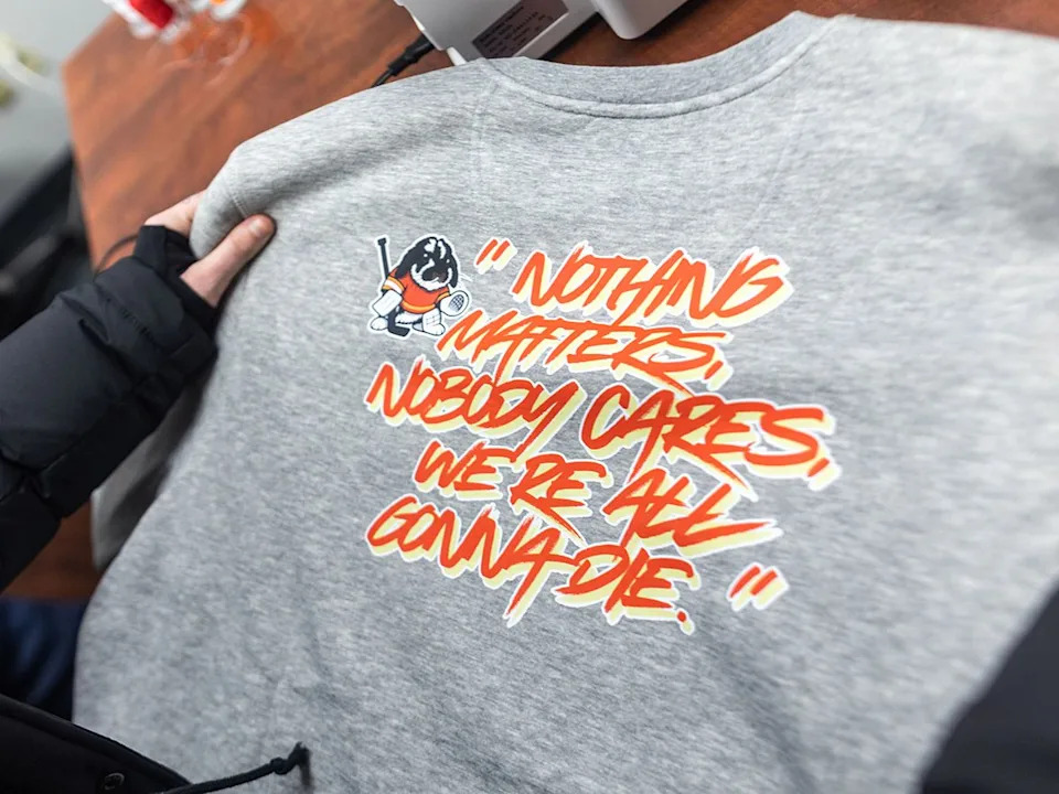  Lex Baxter works to produce sweatshirts for the Tito’s Treasures fundraiser at Parachutes for Pets in Calgary on Monday, Dec. 22, 2025. The initiative was started by Calgary Flames goaltender Devin Cooley with his rabbit Tito, who is featured on the shirts.