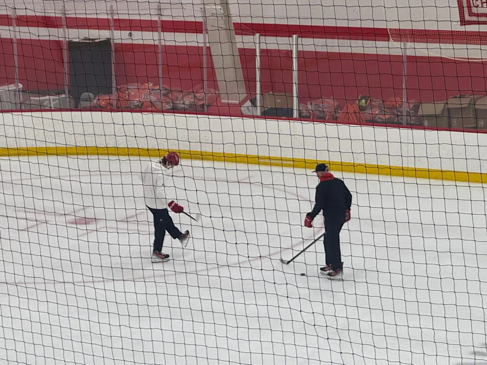 Detroit Red Wings defenseman Moritz Seider on the ice with assistant coach Alex Tanguay on Dec. 19, 2025 in Detroit.