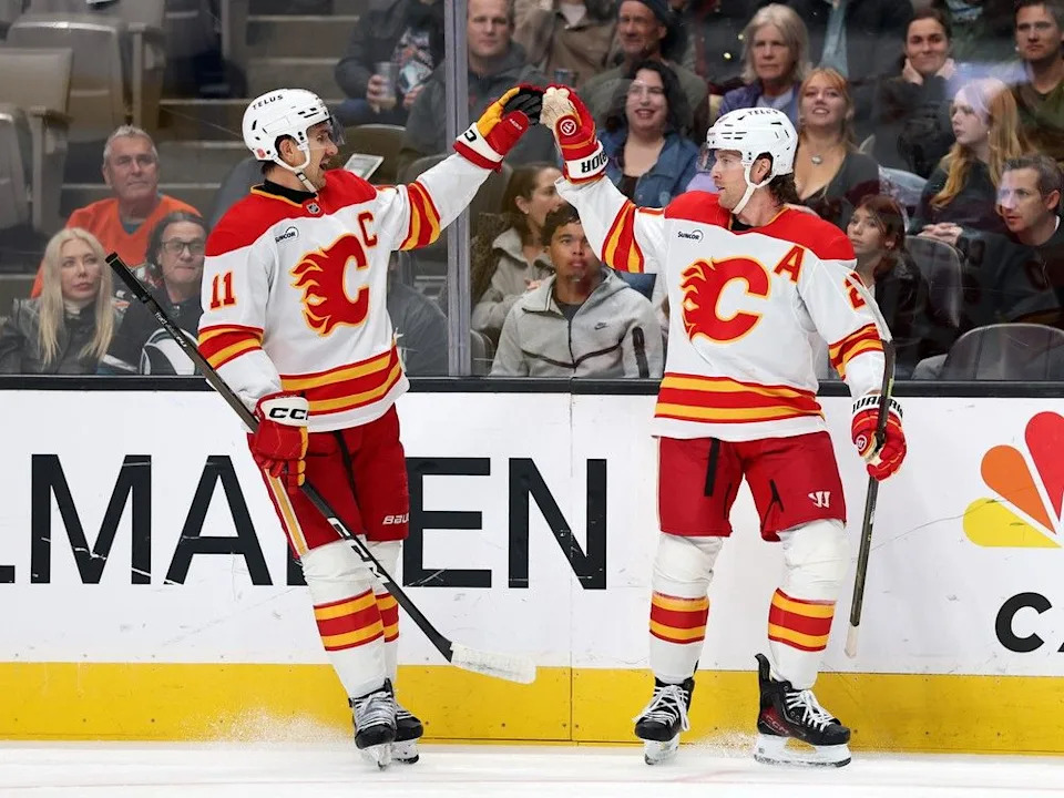  Flames forward Blake Coleman (right) celebrates his goal against the Sharks by Mikael Backlund.