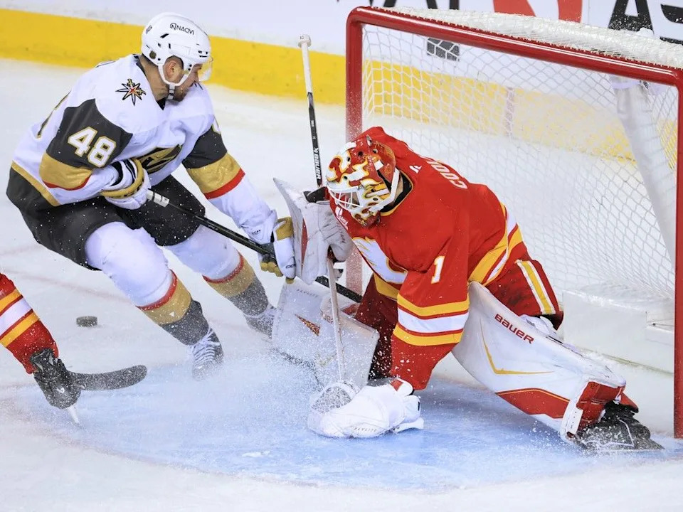 Flames goalie Devin Cooley stops a chance by Golden Knights Golden Knights forward Tomas Hertl.