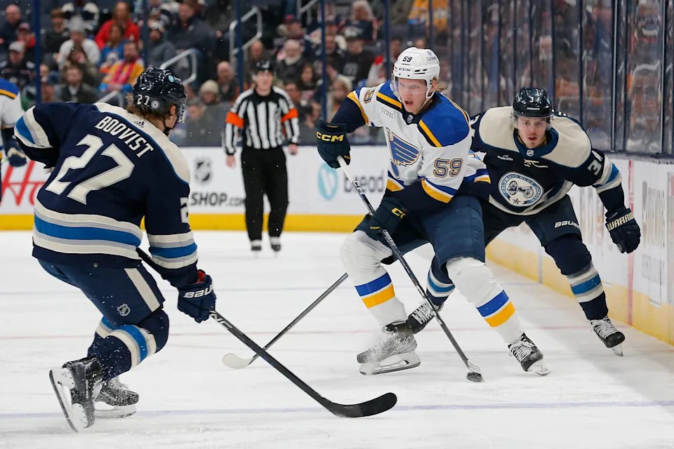 St. Louis Blues center Nikita Alexandrov (59) carries the puck as Columbus Blue Jackets center Cole Sillinger (34) trails the play during the third period at Nationwide Arena.