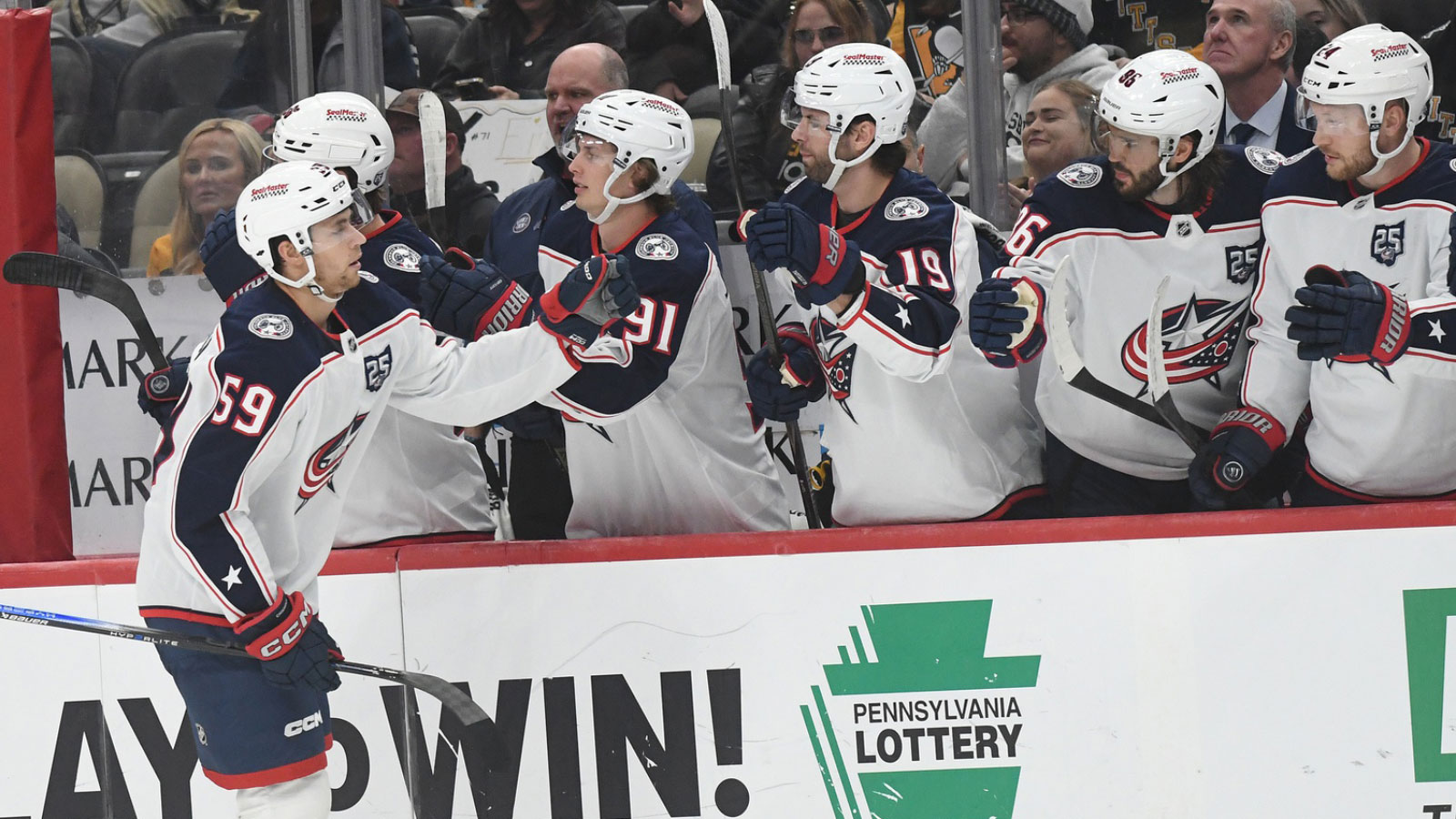 Columbus Blue Jackets right wing Yegor Chinakhov (59) is greeted by the bench after scoring against the Pittsburgh Penguins during the third action at PPG Paints Arena. 