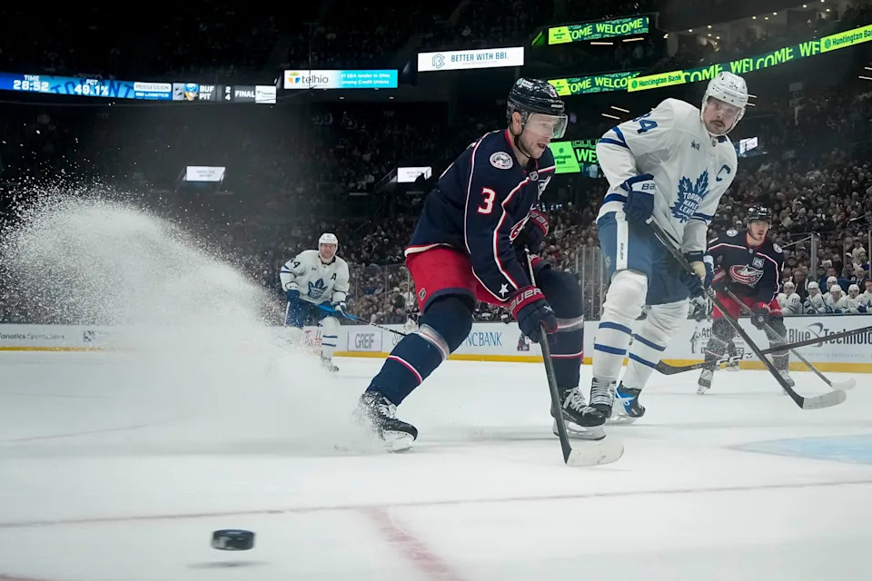 Columbus Blue Jackets center Charlie Coyle (3) tries to corral the puck in front of Toronto Maple Leafs center Auston Matthews (34) during the NHL hockey game at Nationwide Arena in Columbus on Nov. 26, 2025. The Blue Jackets lost 2-1.