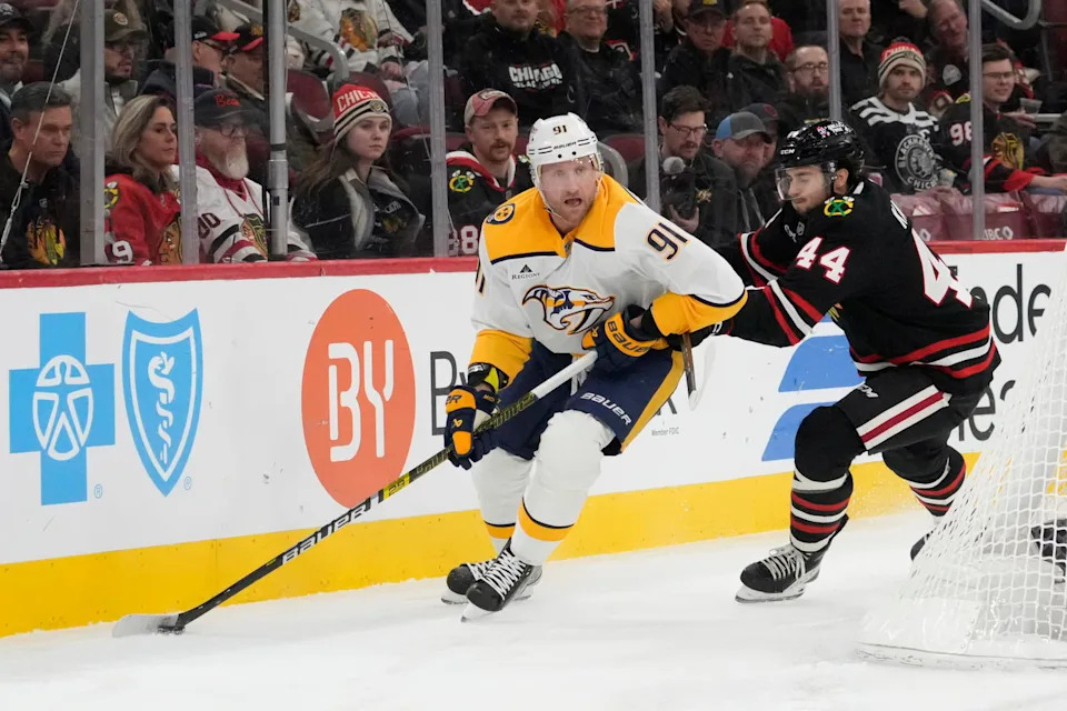 Nov 28, 2025; Chicago, Illinois, USA; Nashville Predators center Steven Stamkos (91) controls the puck against Chicago Blackhawks defenseman Wyatt Kaiser (44) during the first period at United Center. Mandatory Credit: David Banks-Imagn Images