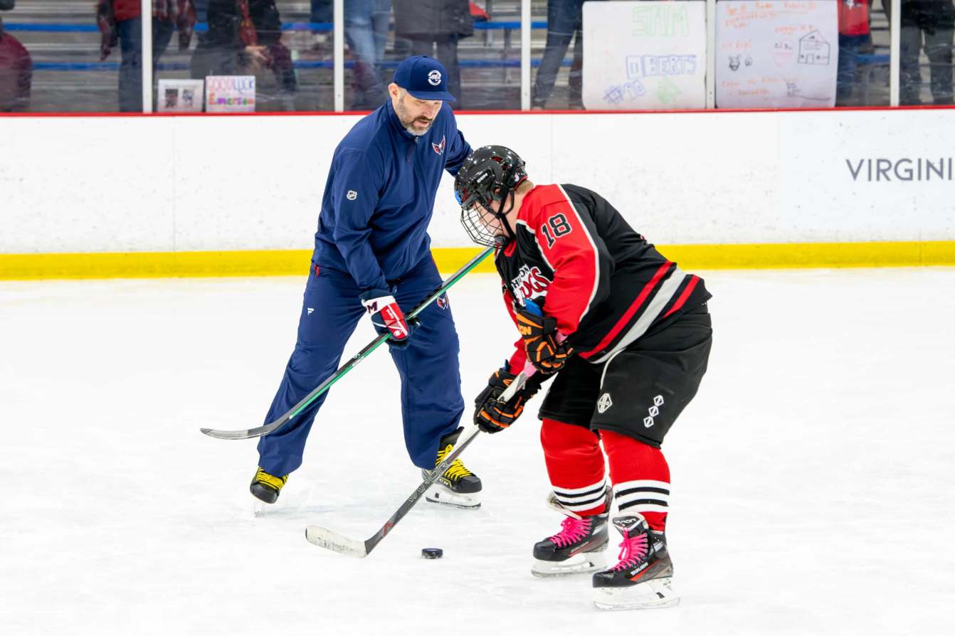 Alex Ovechkin skates with a young player at the American Special Hockey Association clinic
