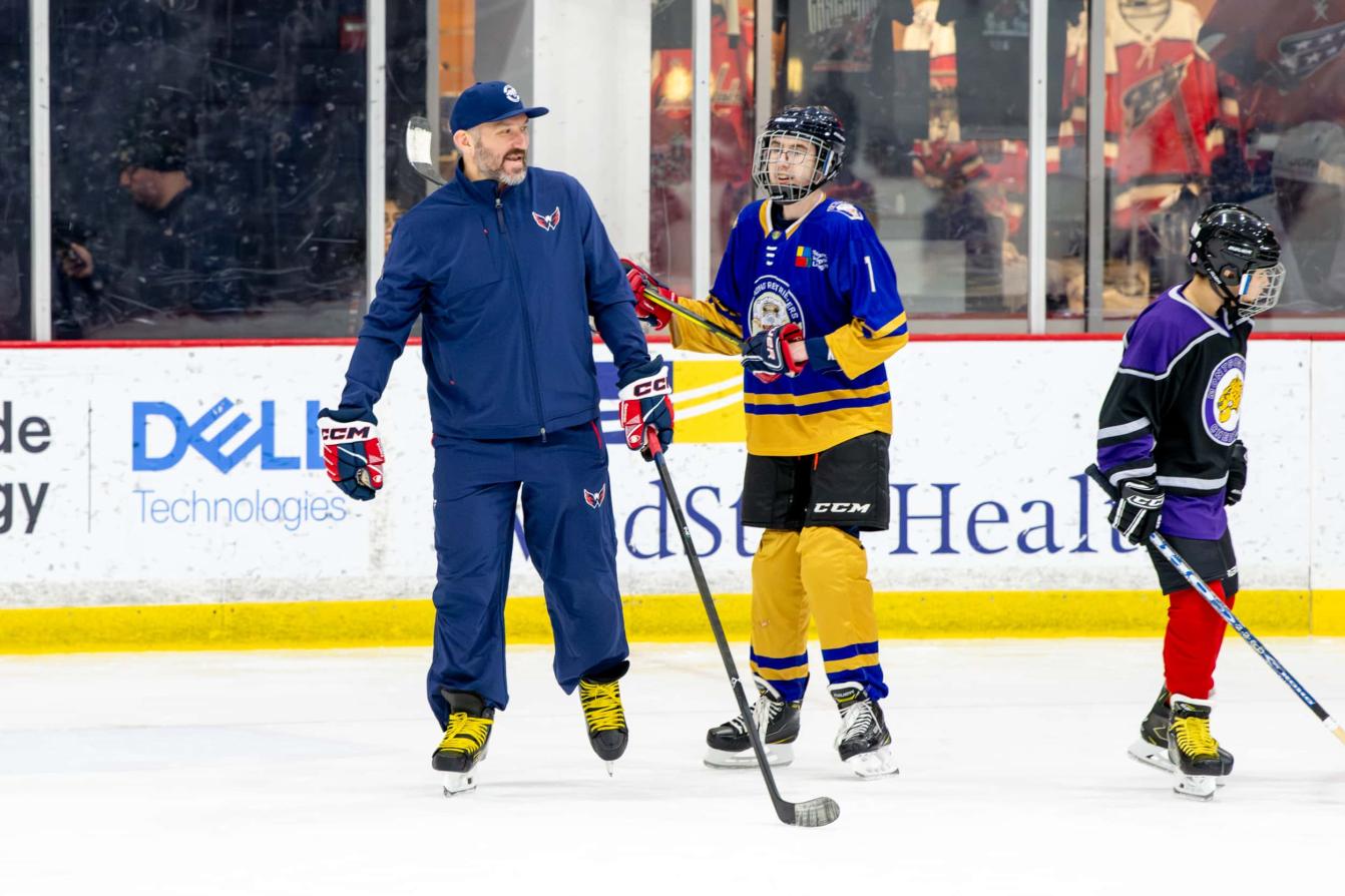 Alex Ovechkin skates with a young player at the American Special Hockey Association clinic