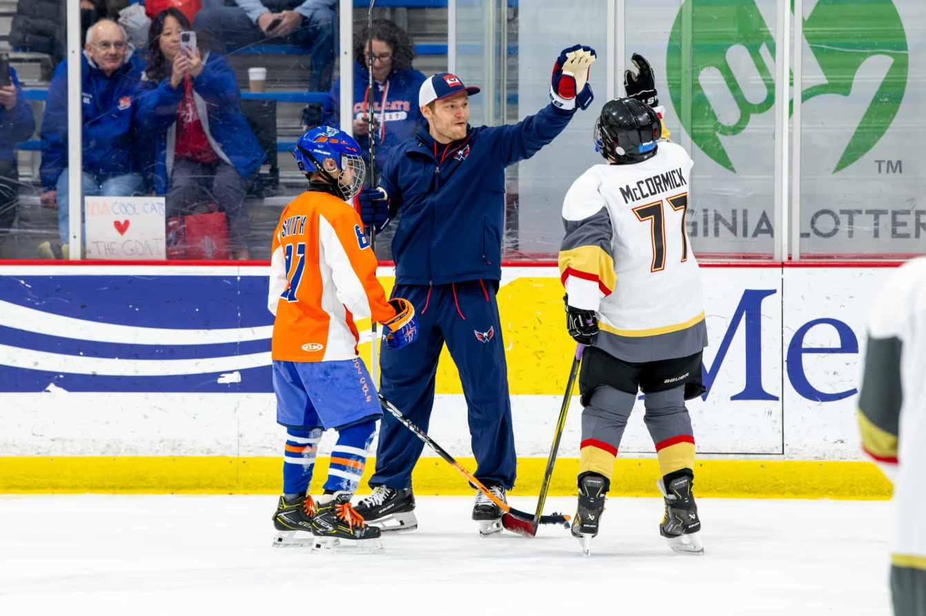 Ethen Frank high-fives a participant at the American Special Hockey Association clinic