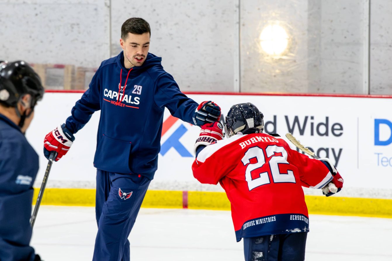 Hendrix Lapierre gives a child a fistbump at the American Special Hockey Association clinic