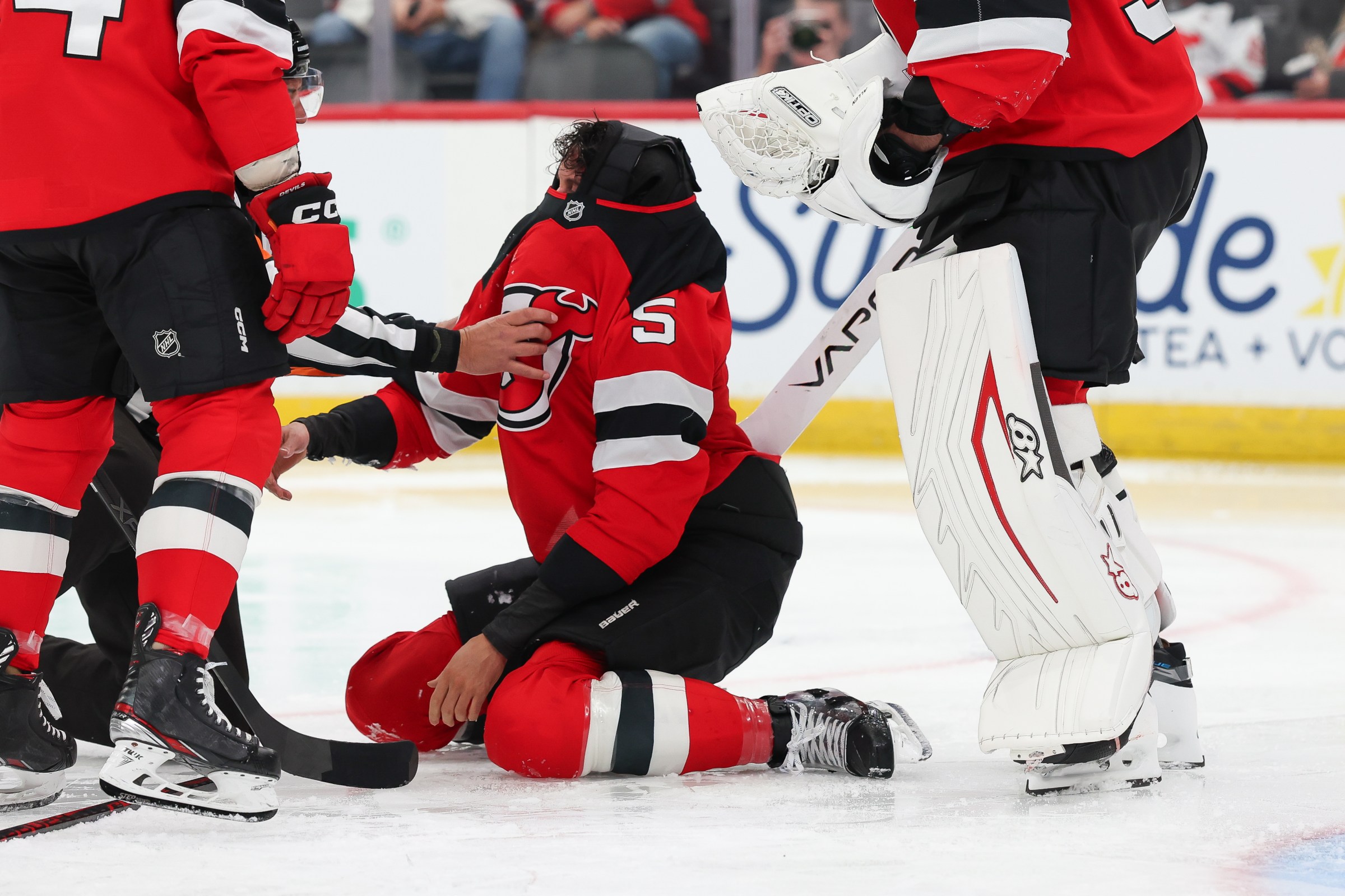 NEWARK, NJ - DECEMBER 01: Brenden Dillon #5 of the New Jersey Devils is attended to by a referee after a fight during a game between the Columbus Blue Jackets and New Jersey Devils at Prudential Center on December 1, 2025 in Newark, New Jersey. (Photo by Andrew Mordzynski/Icon Sportswire via Getty Images)