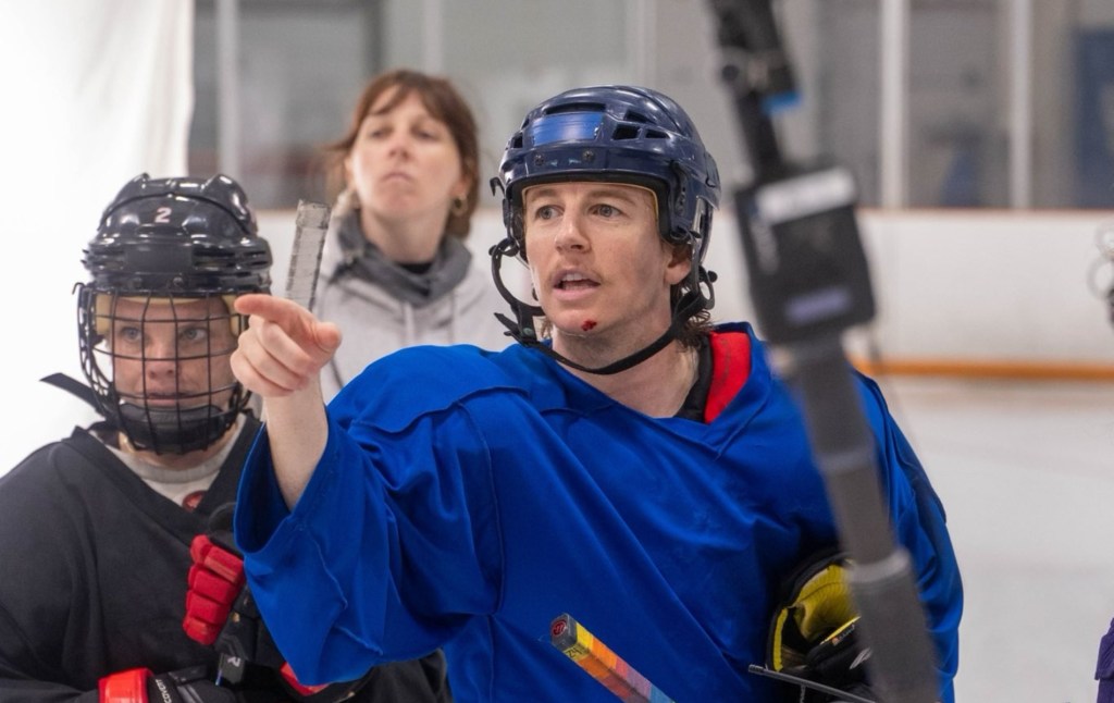 Harrison Browne oon the hockey rink directing