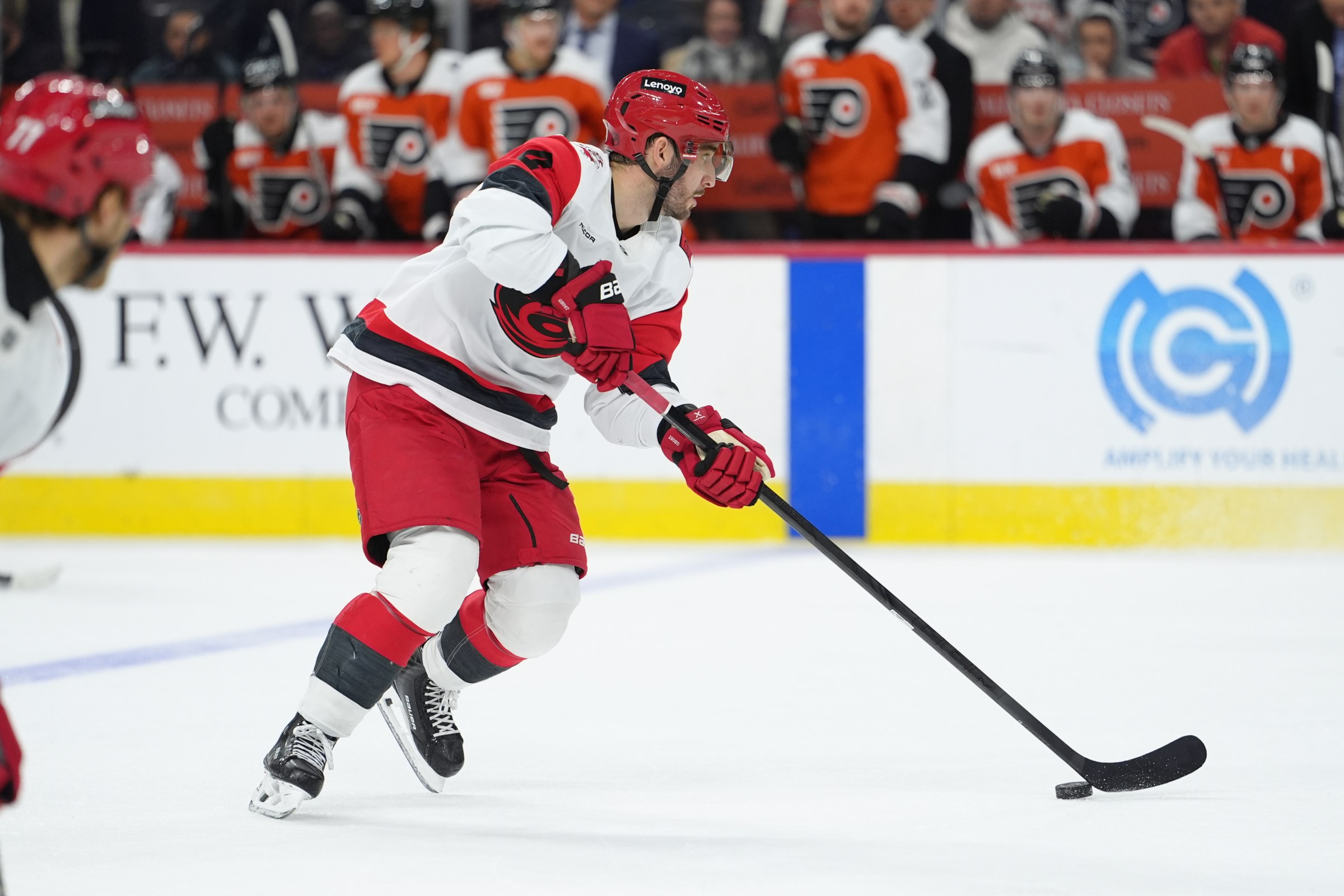 Dec 13, 2025; Philadelphia, Pennsylvania, USA; Carolina Hurricanes defenseman Shayne Gostisbehere (4) controls the puck against the Philadelphia Flyers in the first period at Xfinity Mobile Arena. Mandatory Credit: Kyle Ross-Imagn Images