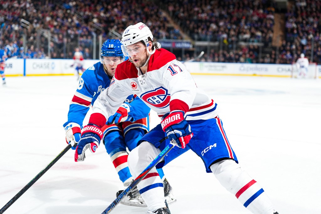 Josh Anderson of the Montreal Canadiens skates with the puck against Urho Vaakanainen of the New York Rangers.
