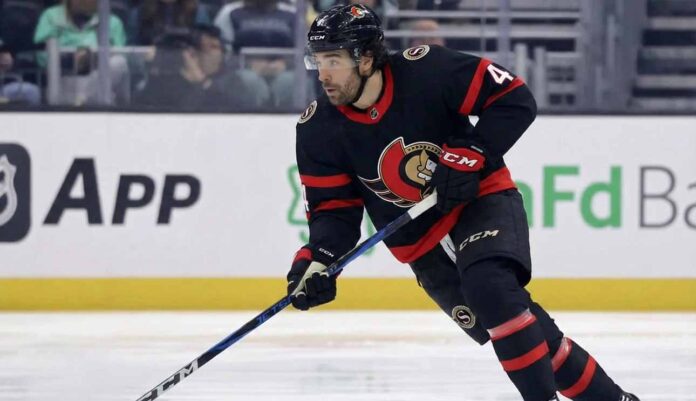 Ottawa Senators forward Kiefer Sherwood skating with the puck during an NHL game, wearing the team's black home uniform with red and white trim.
