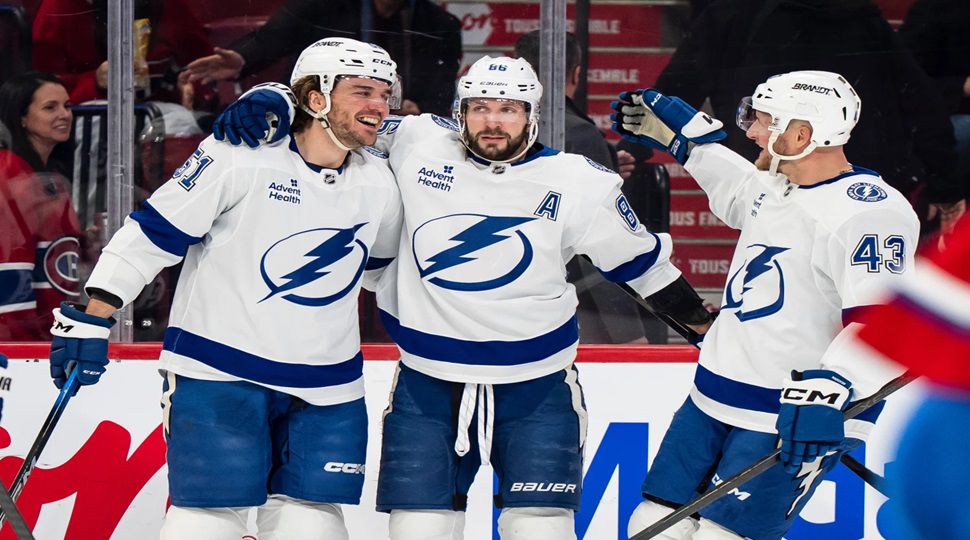 Tampa Bay Lightning's Charle-Edouard D'Astous (51) celebrates his goal with teammates Nikita Kucherov (86) and Darren Raddysh (43) during second period NHL hockey action against the Montreal Canadiens in Montreal on Tuesday, Dec. 9, 2025. (Christopher Katsarov/The Canadian Press via AP)