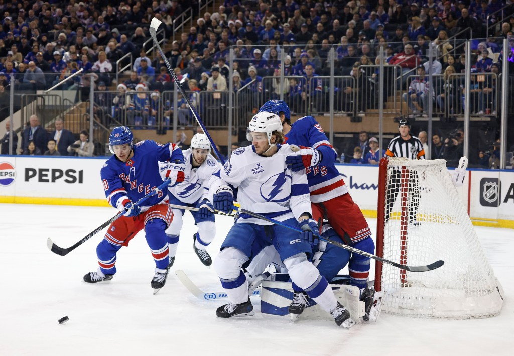 Tampa Bay Lightning defenseman Charle-Edouard D'Astous (51) holds back New York Rangers left wing Will Cuylle (50) during the first period.